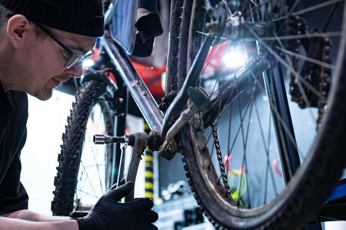 A bike mechanic working on a bicycle