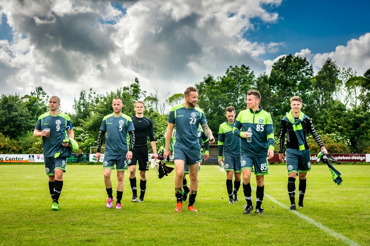 Players of a local football club walking off the pitch